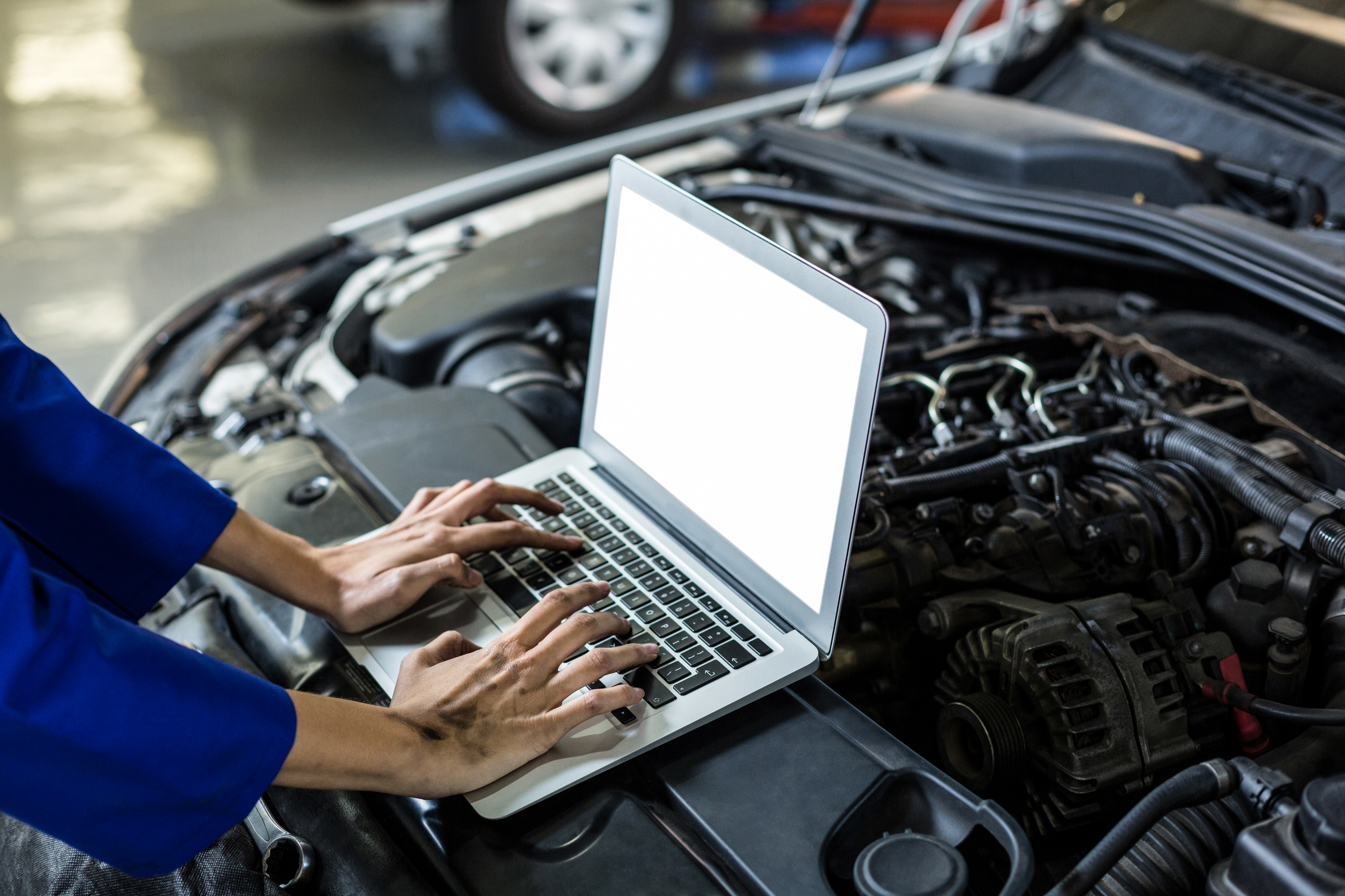 hands-female-mechanic-using-laptop